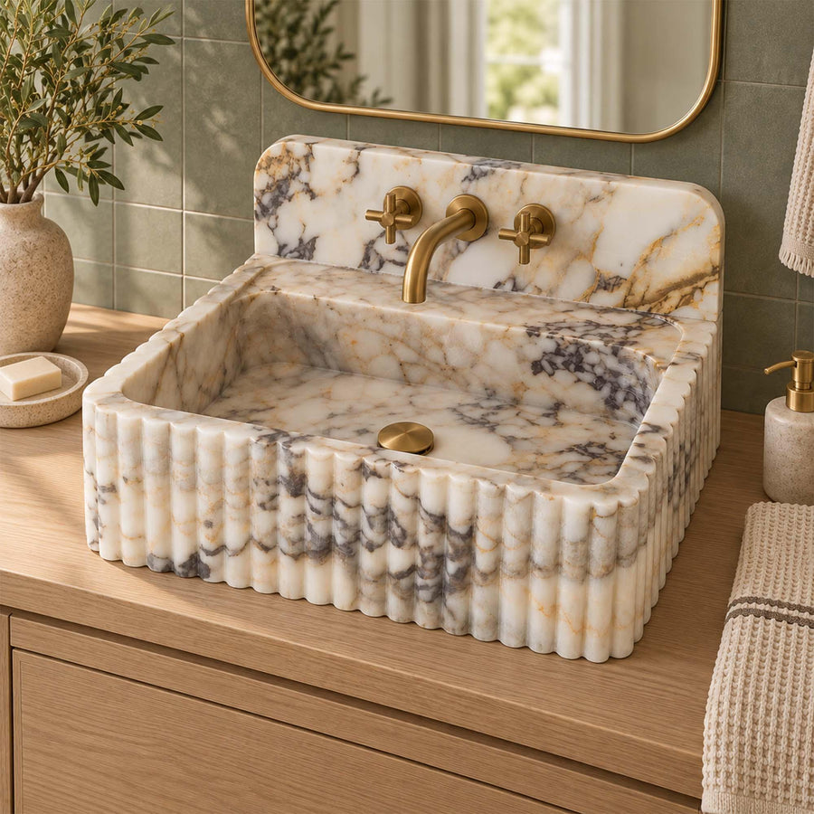 Calacatta Gold fluted vanity sink detail showing hand-carved edges