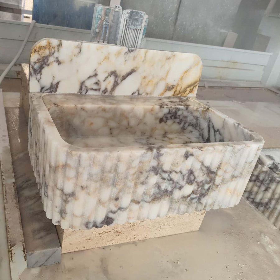 Close-up of natural veining on a Calacatta Gold fluted vanity sink