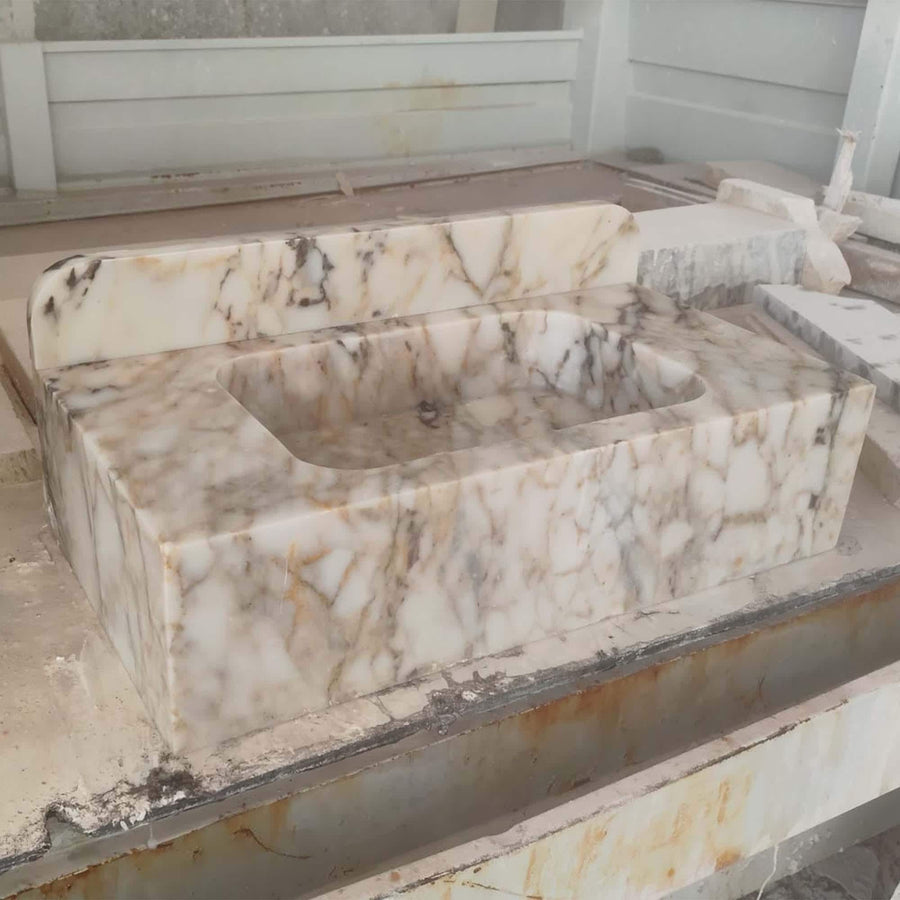 Angled view of a handcrafted Calacatta Gold bathroom sink