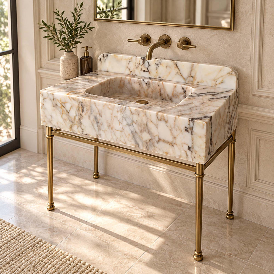 Calacatta Gold smooth console sink with rounded backsplash styled in a designer powder room