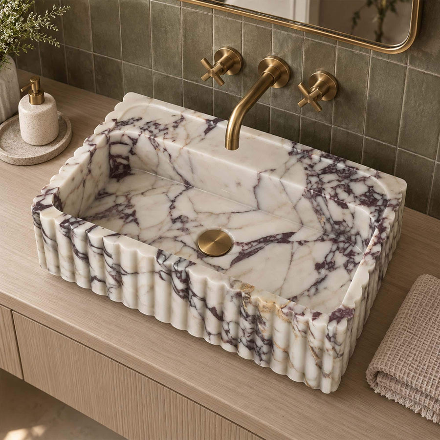 Calacatta Viola fluted floating sink with rear deck on a custom brass vanity stand