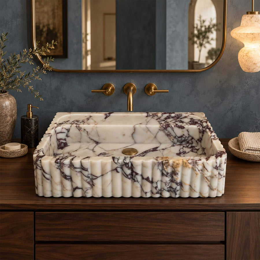 Side view of a solid Calacatta Viola fluted floating sink