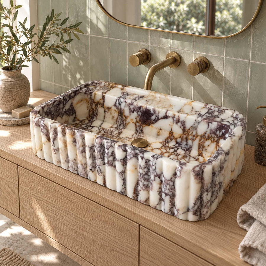 Calacatta Viola rounded fluted floating sink on a wood vanity cabinet