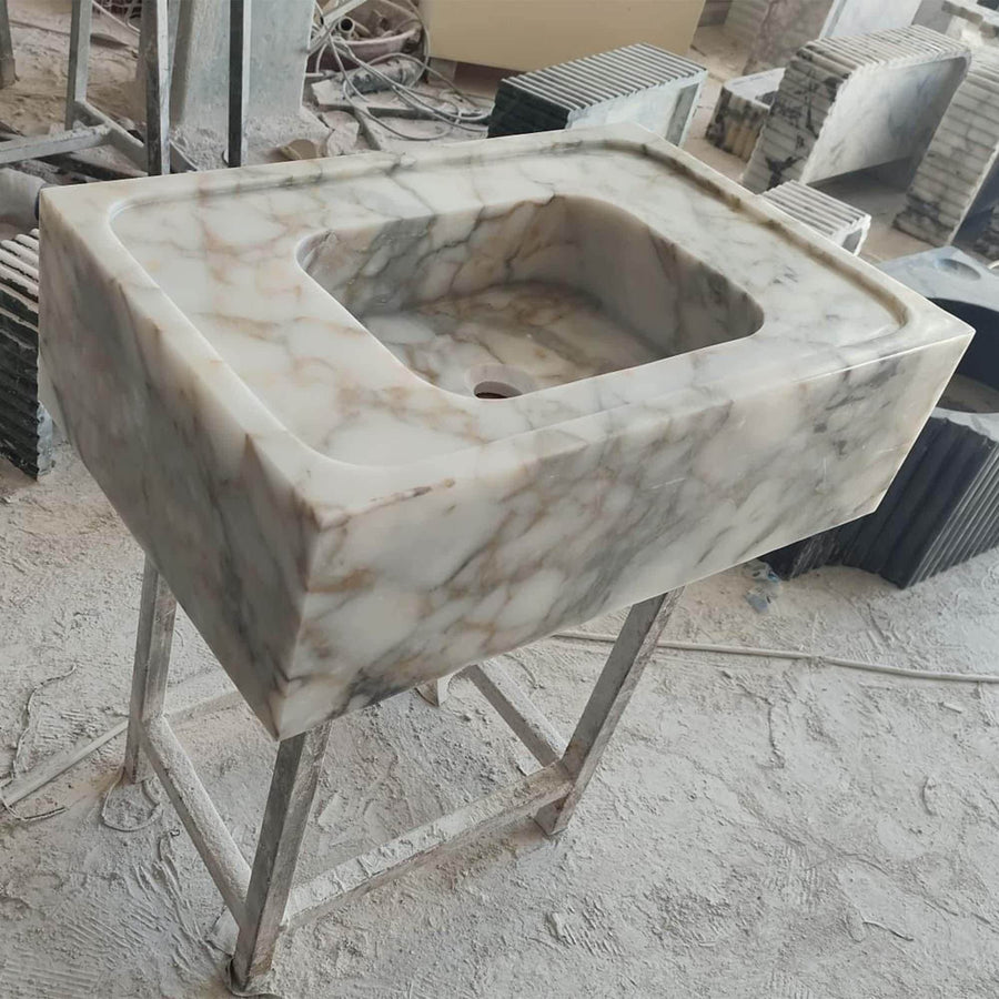 Side view of a solid Calacatta Gold smooth floating sink