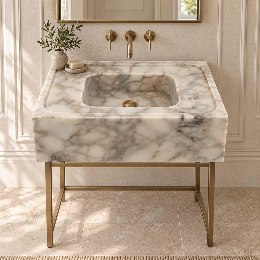 Calacatta Gold smooth marble sink with wide deck styled in a designer powder room