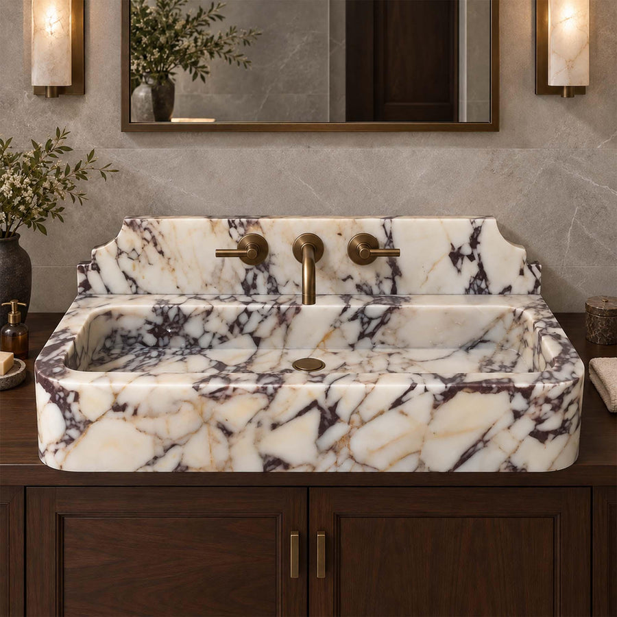 Calacatta Viola smooth console sink detail showing hand-carved edges