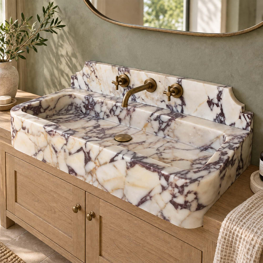 Natural stone smooth console sink in Calacatta Viola with brass fittings