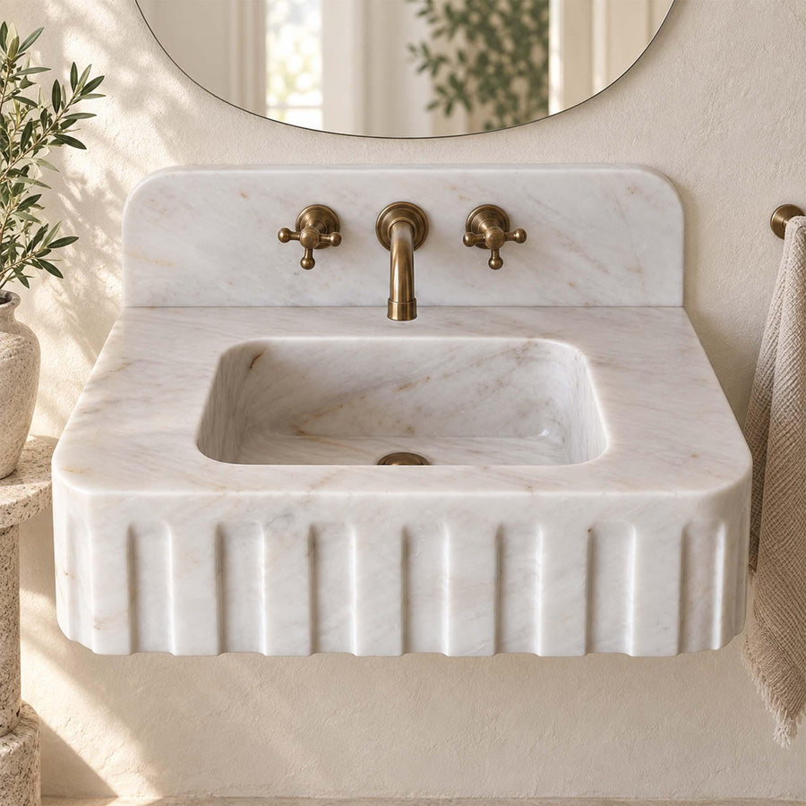 Top view of the deep integrated basin of a Carrara White fluted vanity sink