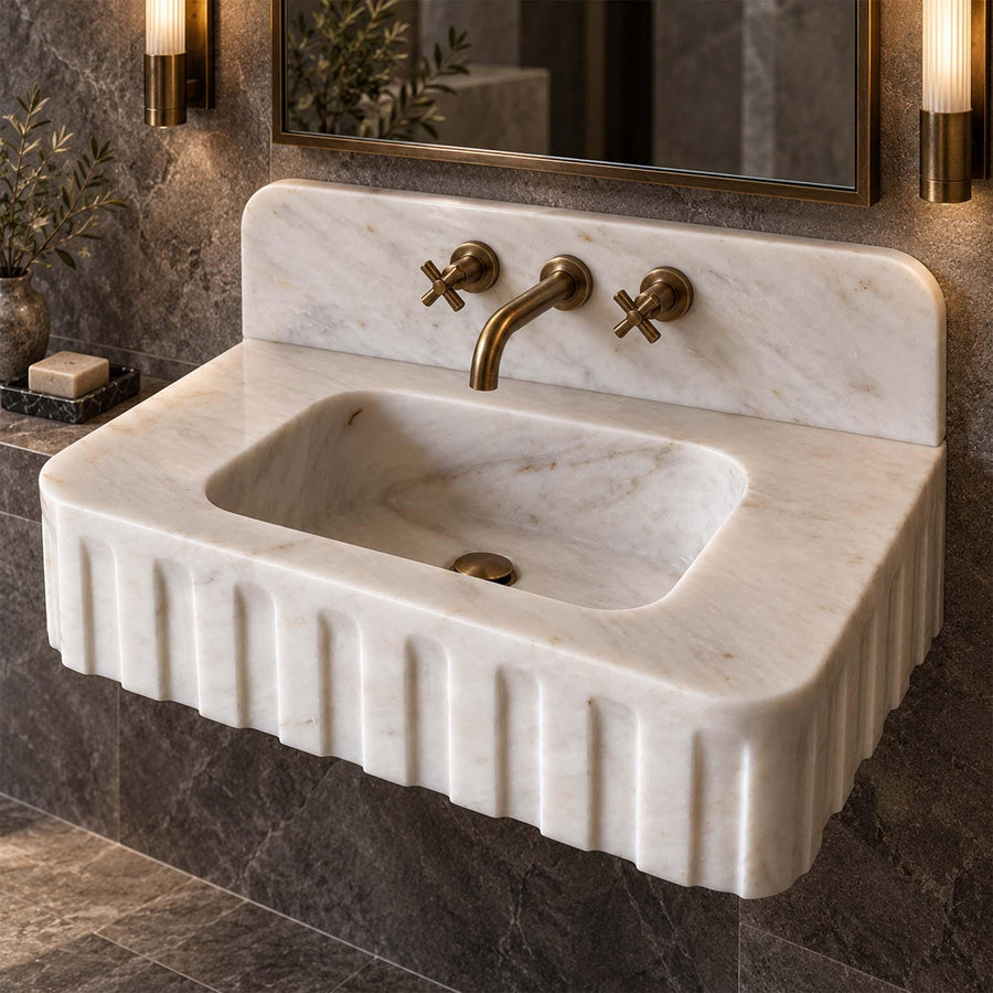 Side view of a solid Carrara White fluted vanity sink