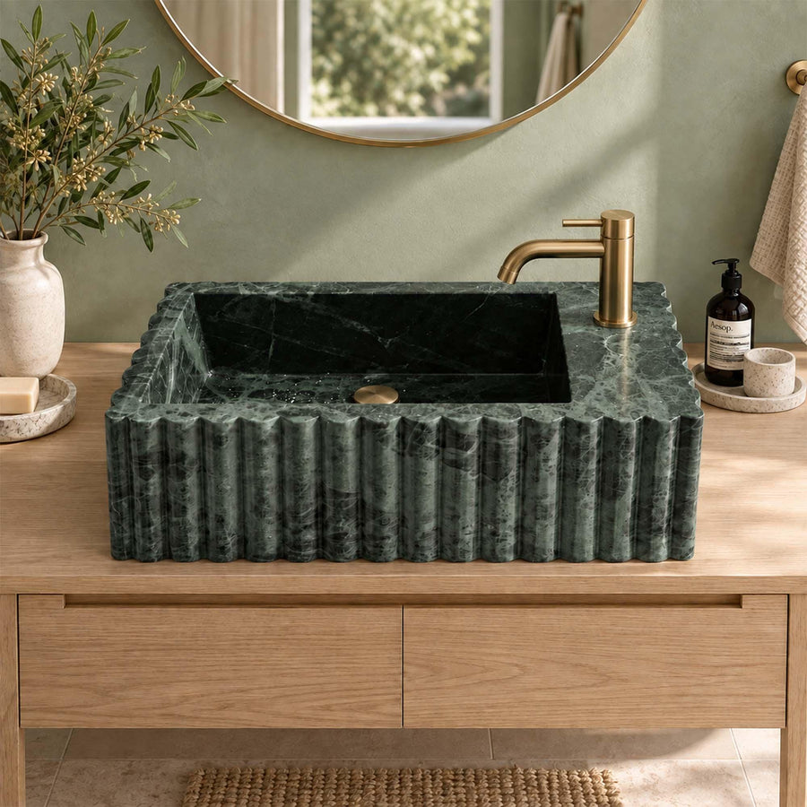 Green Levanto fluted vanity sink detail showing hand-carved edges