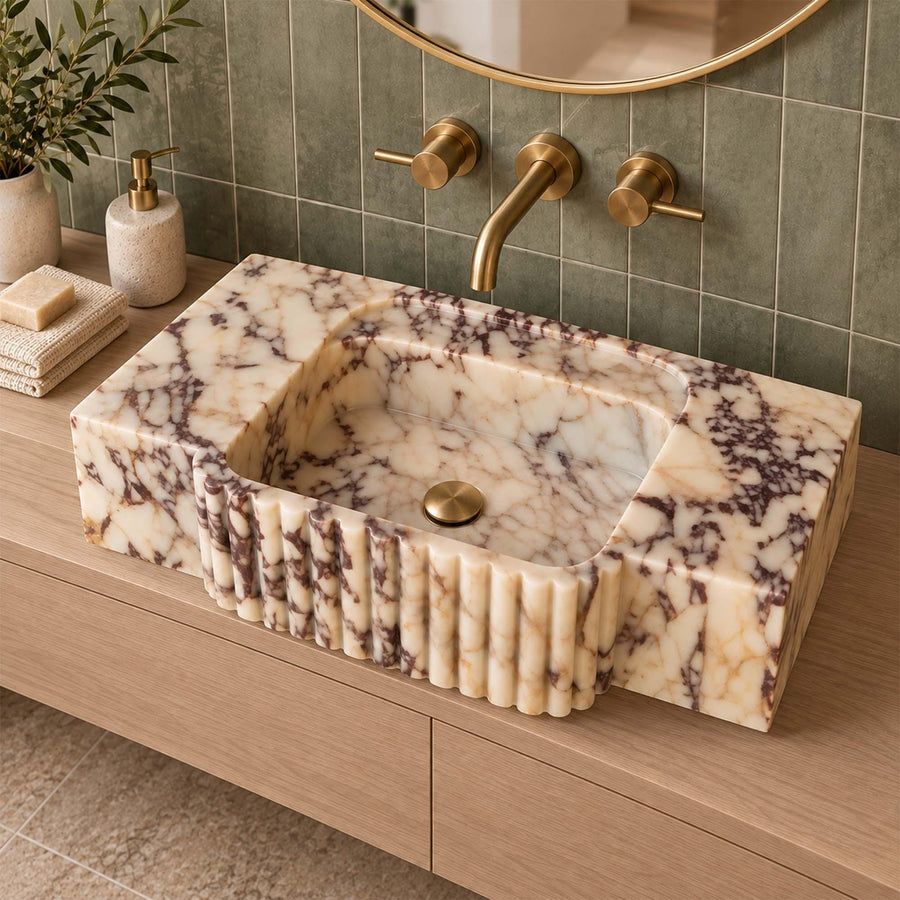 Calacatta Viola marble console sink with fluted center apron in a luxury bathroom