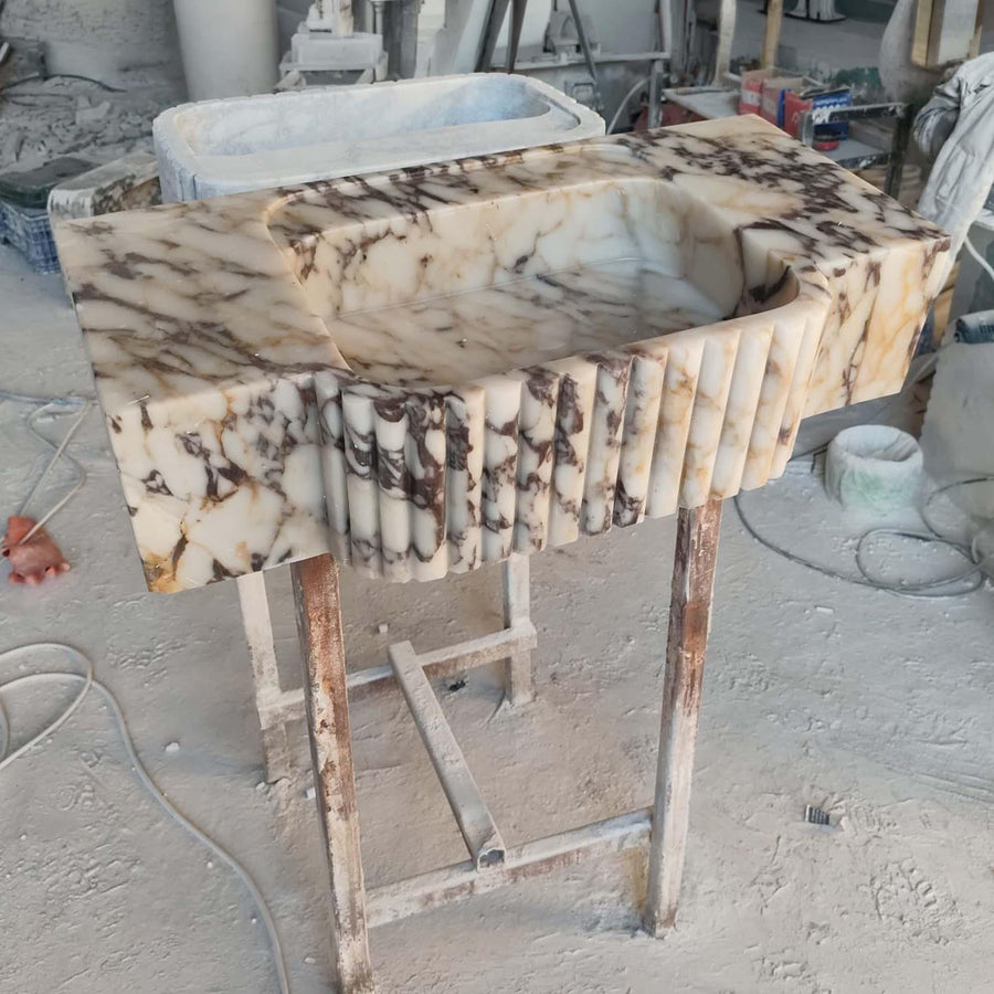 Close-up of natural veining on a Calacatta Viola fluted apron console sink