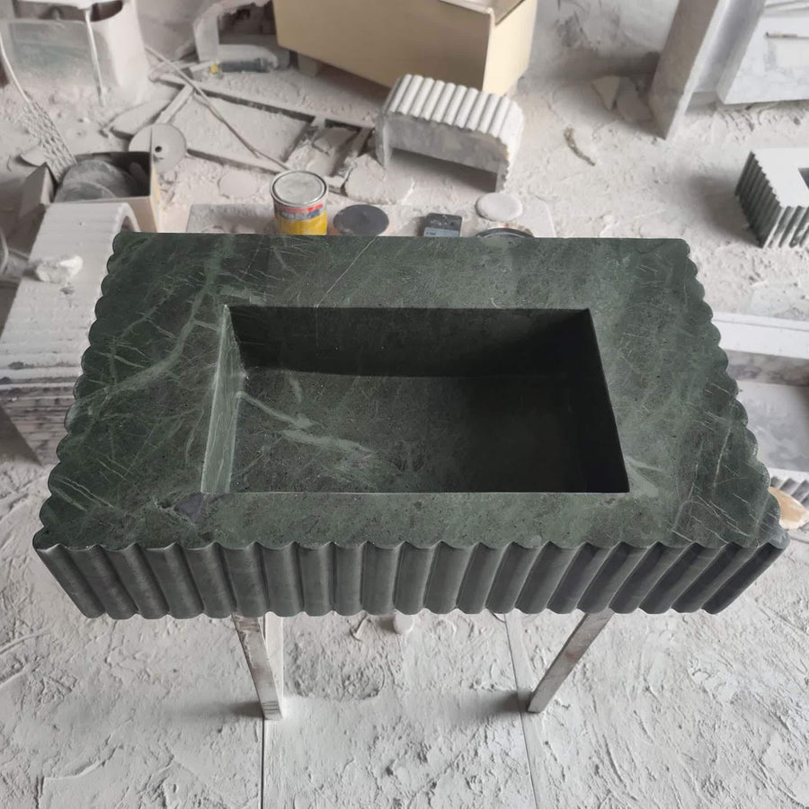 Rectangular dark green marble sink with scalloped rim, vertical fluting and deep polished basin