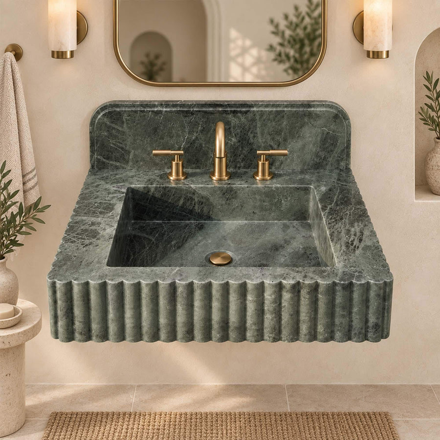 Side view of green marble fluted sink showing scalloped rim and backsplash profile