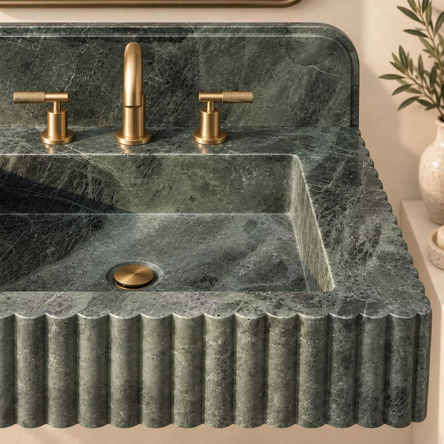 Green marble fluted sink with rounded backsplash styled with towel and mirror
