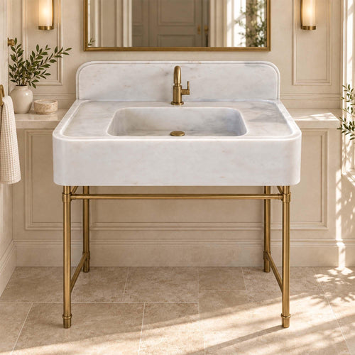 Carrara White marble console sink with integrated backsplash on a custom brass vanity stand
