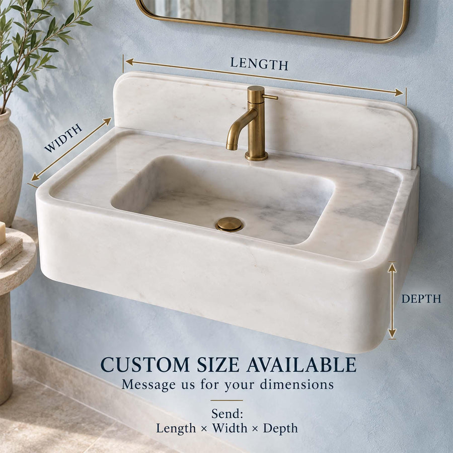 Front view of a hand-carved Carrara White console sink