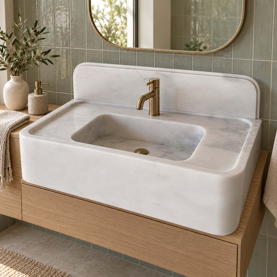 Carrara White console sink detail showing hand-carved edges