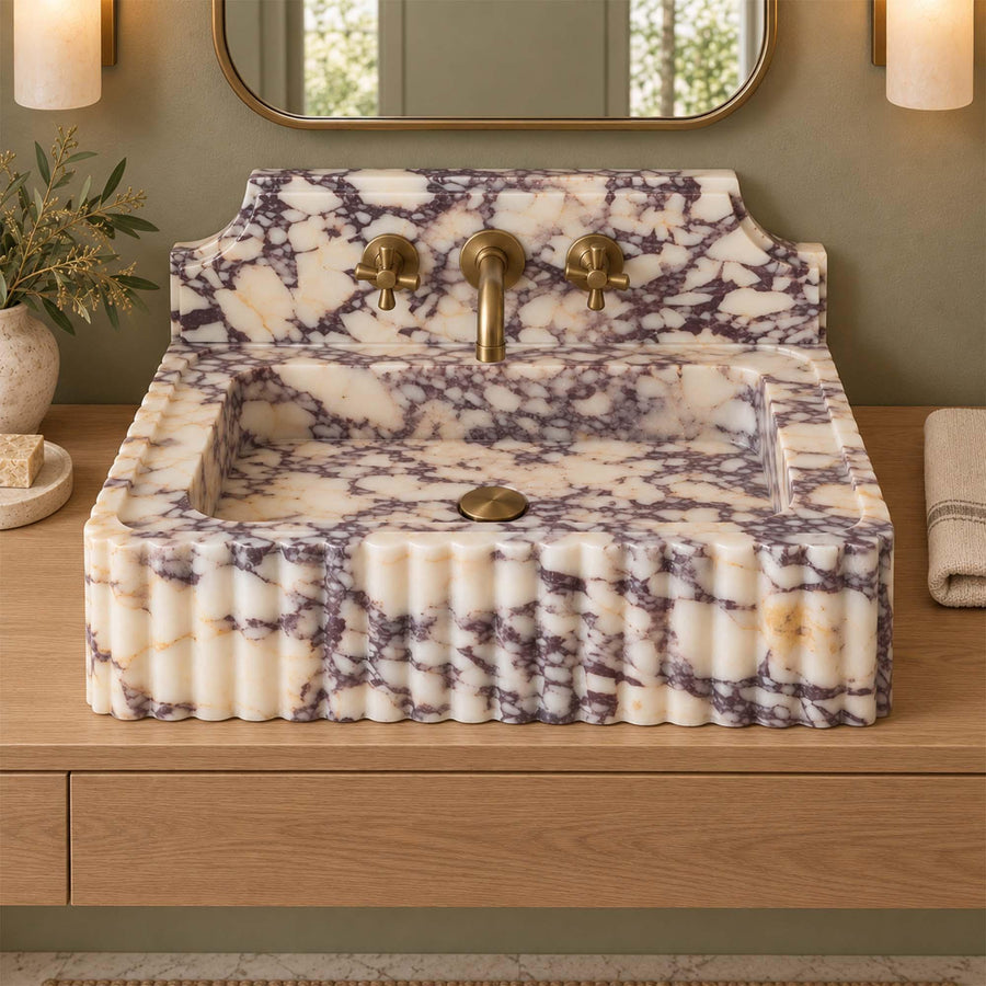 Calacatta Viola fluted console sink detail showing hand-carved edges