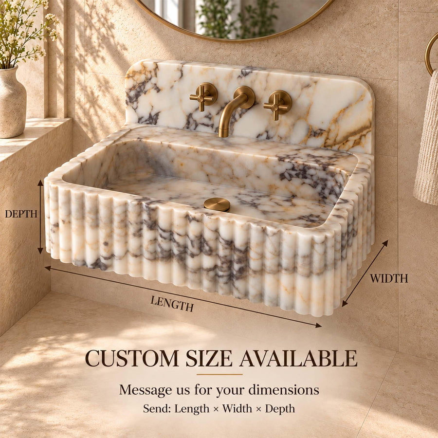 Calacatta Gold fluted vanity sink with rounded backsplash in a luxury bathroom