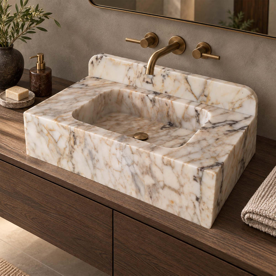 Natural stone smooth console sink in Calacatta Gold with brass fittings