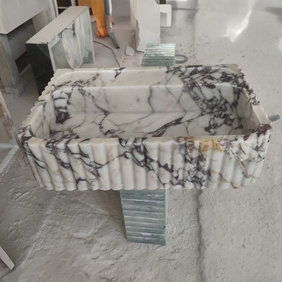 Calacatta Viola fluted floating sink with rear deck in a luxury bathroom