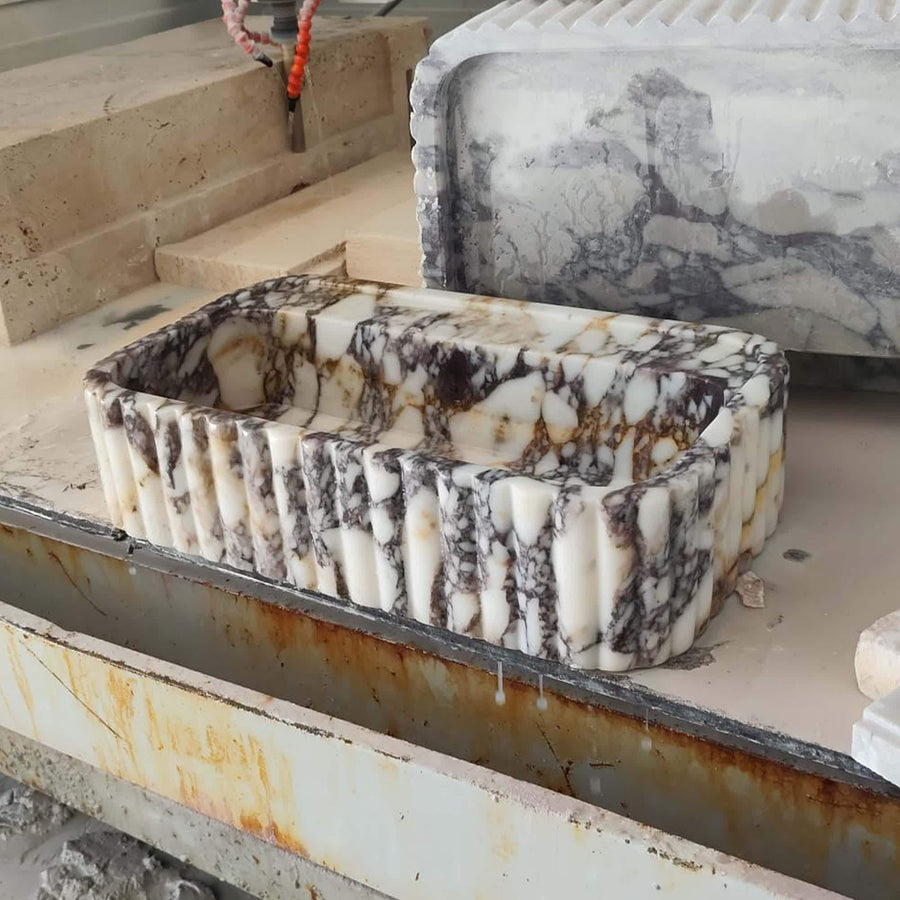 Angled view of a handcrafted Calacatta Viola bathroom sink