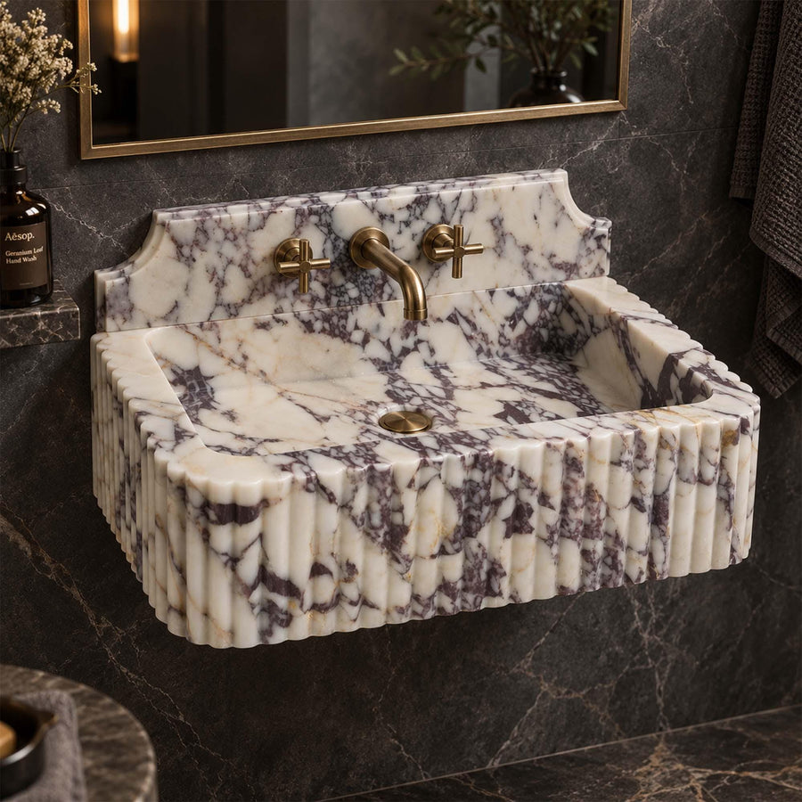 Top view of the deep integrated basin of a Calacatta Viola fluted console sink