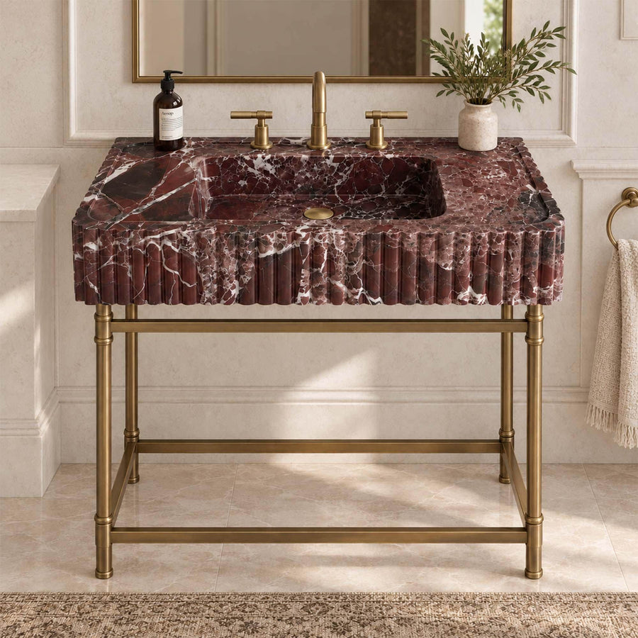 Rosso Levanto red marble fluted console sink on a custom brass vanity stand