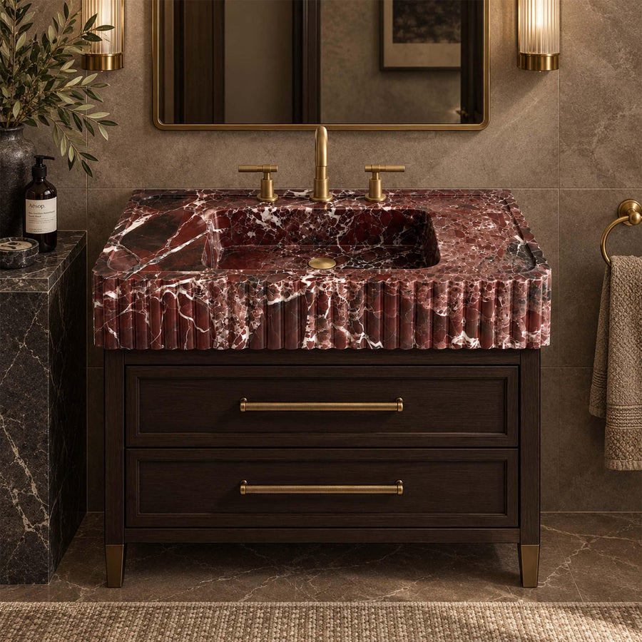 Rosso Levanto red marble fluted console sink on a wood vanity cabinet