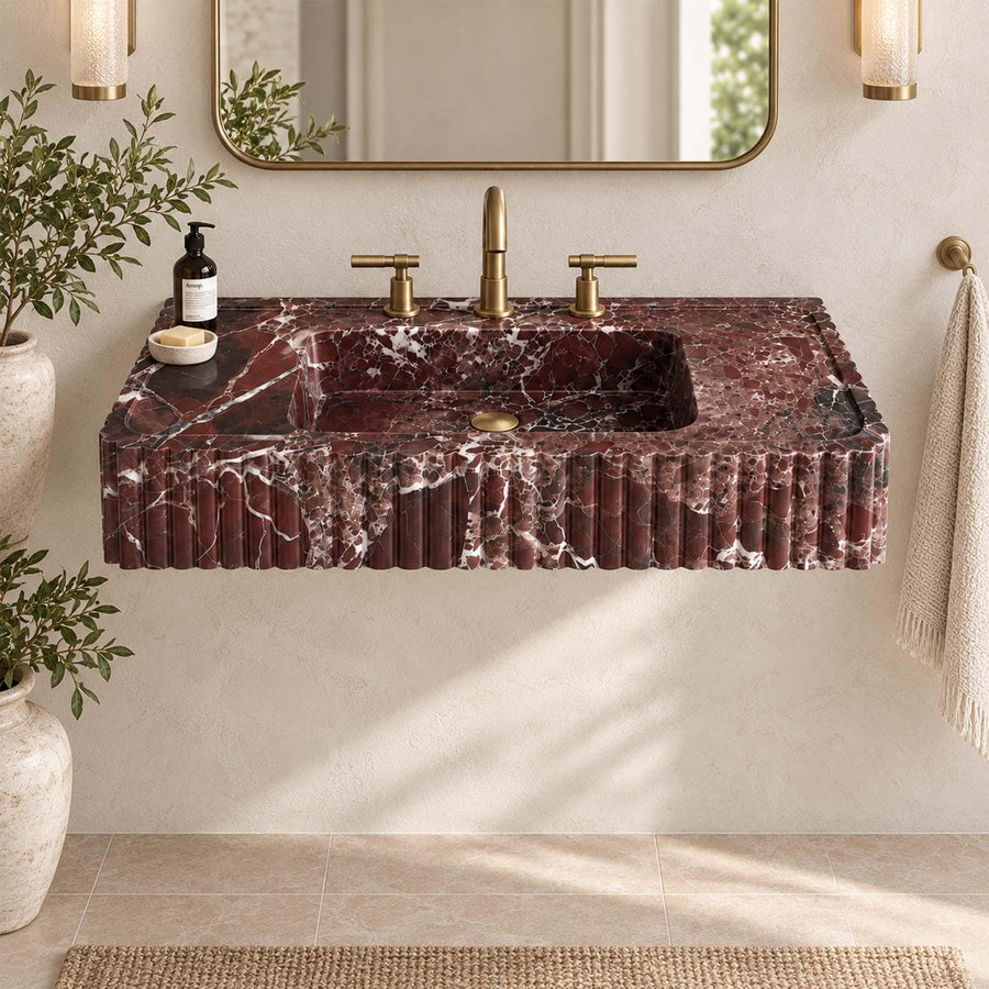Side view of a solid Rosso Levanto fluted console sink