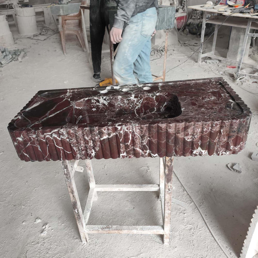 Rosso Levanto red marble fluted console sink in a luxury bathroom