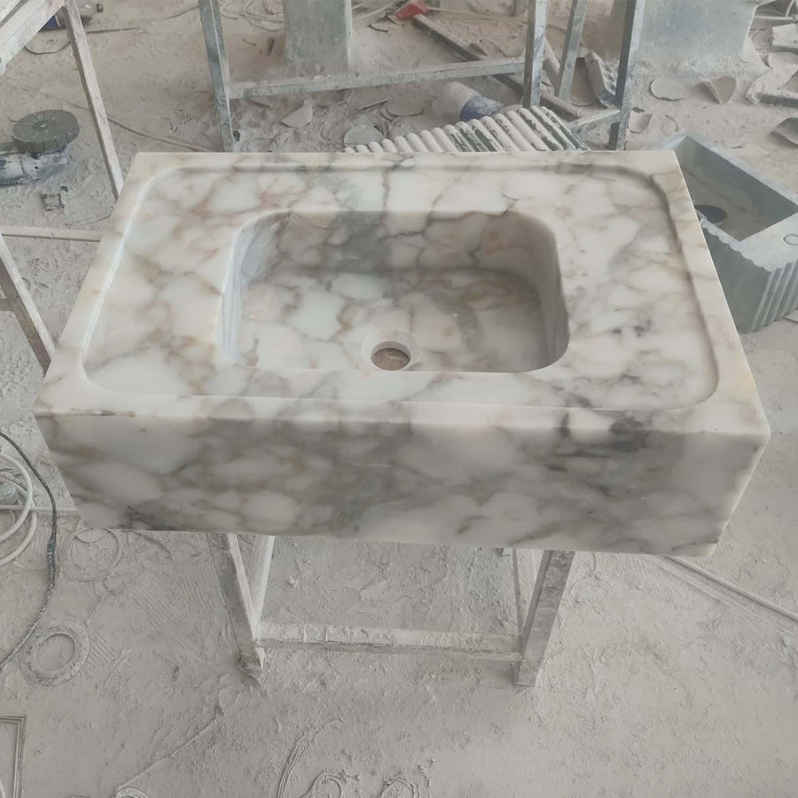 Top view of the deep integrated basin of a Calacatta Gold smooth floating sink