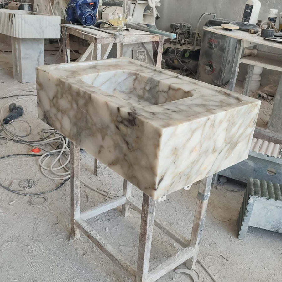 Calacatta Gold smooth marble sink with wide deck in a luxury bathroom