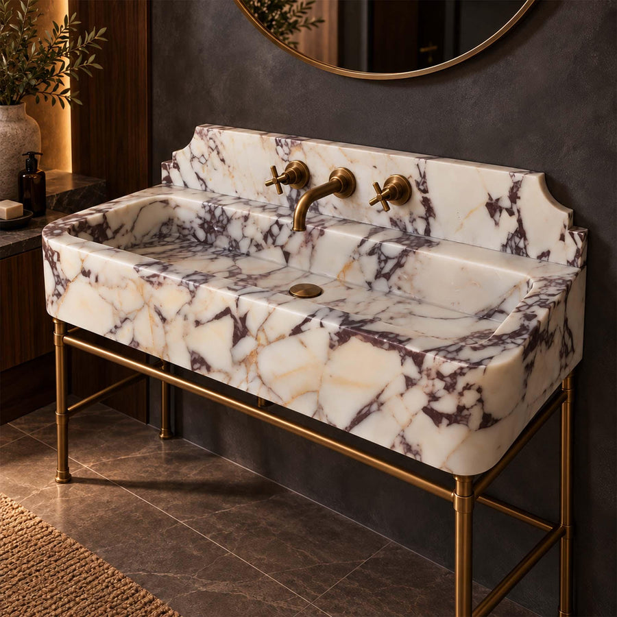 Calacatta Viola smooth console sink with decorative backsplash styled in a designer powder room