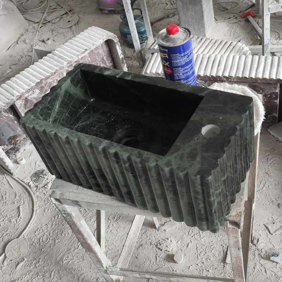 Side view of a solid Green Levanto fluted vanity sink