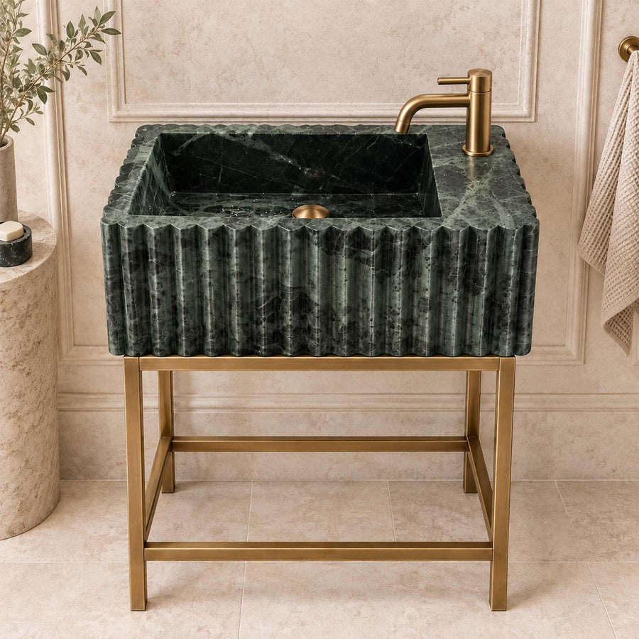 Green marble fluted vanity sink with single faucet hole styled in a designer powder room