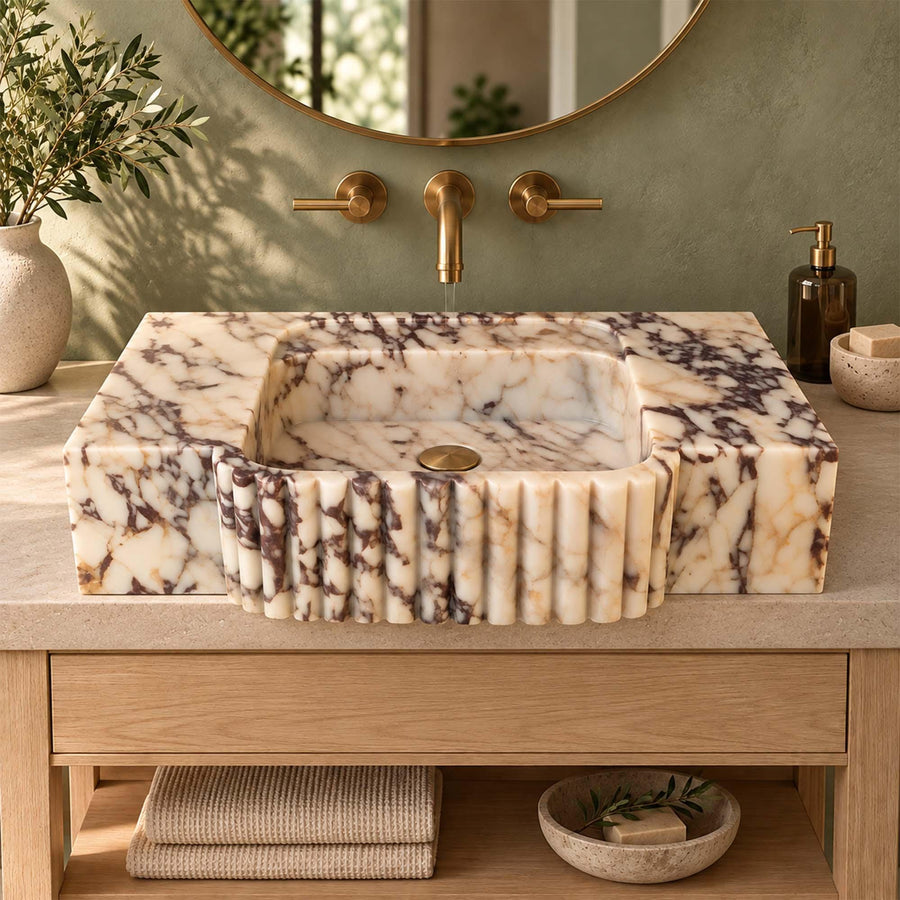 Angled view of a handcrafted Calacatta Viola bathroom sink