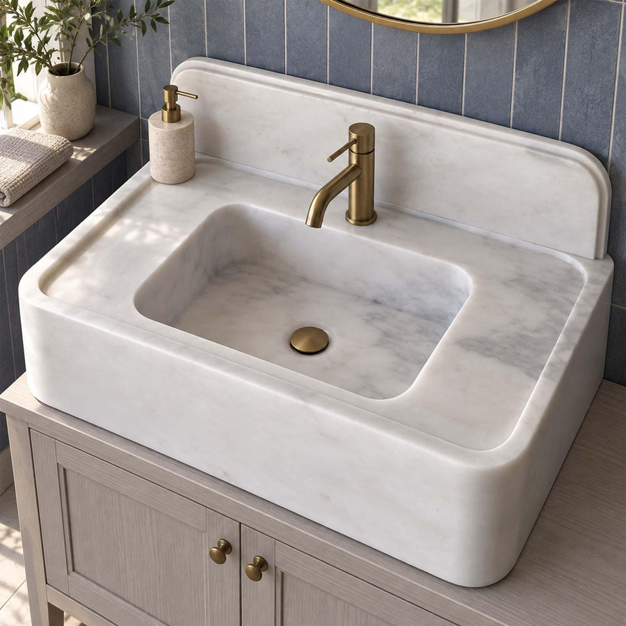 Carrara White marble console sink with integrated backsplash in a luxury bathroom