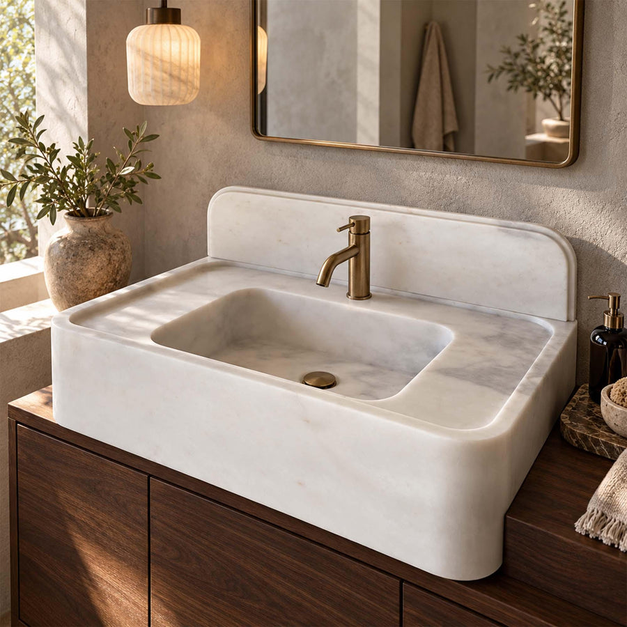 Natural stone console sink in Carrara White with brass fittings
