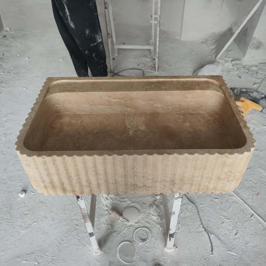 Top view of the deep integrated basin of a Beige Travertine fluted console sink
