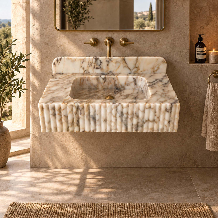 Calacatta Gold fluted floating sink detail showing hand-carved edges