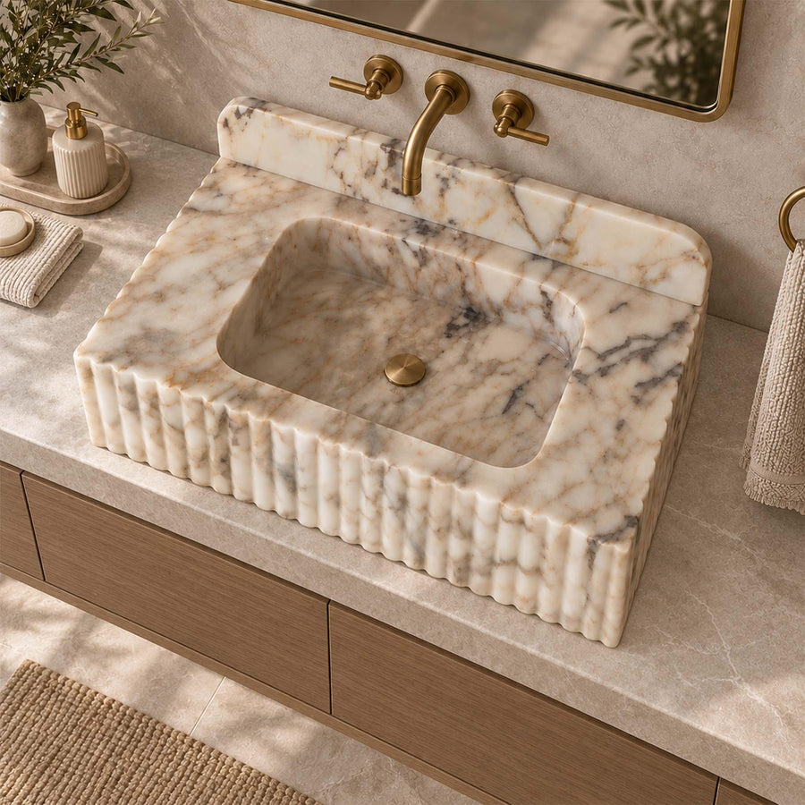 Side view of a solid Calacatta Gold fluted floating sink