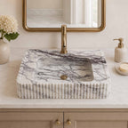 Marble sink with faucet in a bathroom setting