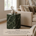 Marble side table in a living room setting with a sofa and decor items.