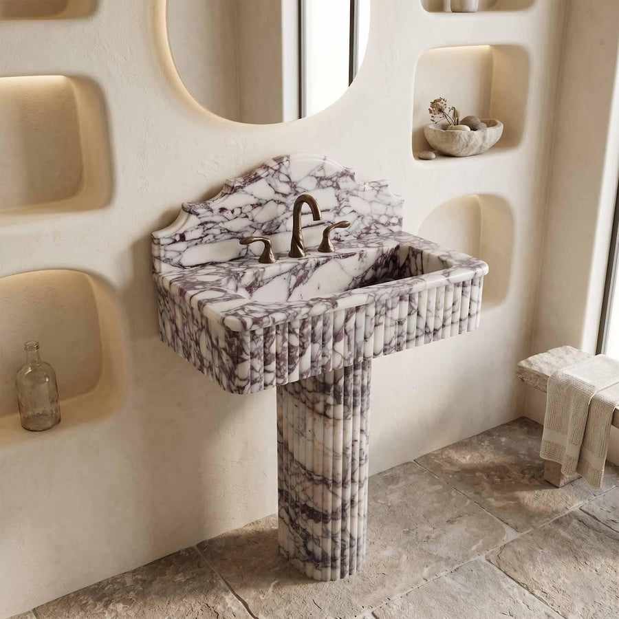 Calacatta viola marble sink with pedestal in a bathroom