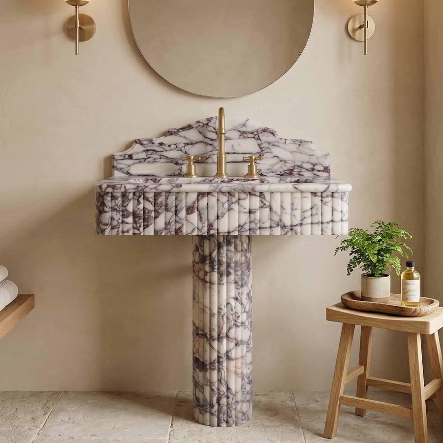 Calacatta viola marble sink with pedestal in a bathroom