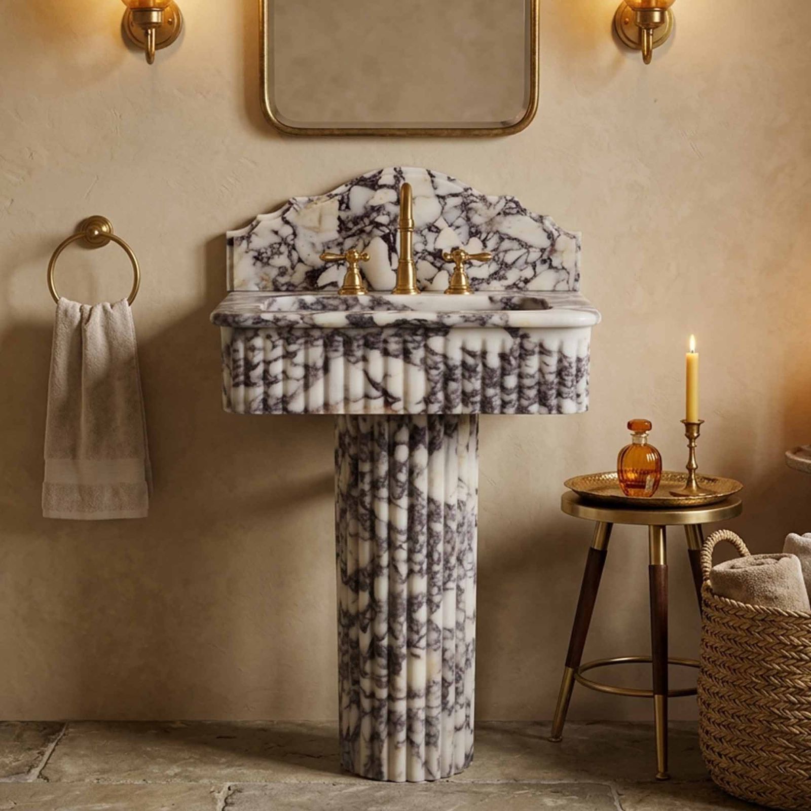 Marble pedestal sink with scalloped backsplash and brass fixtures