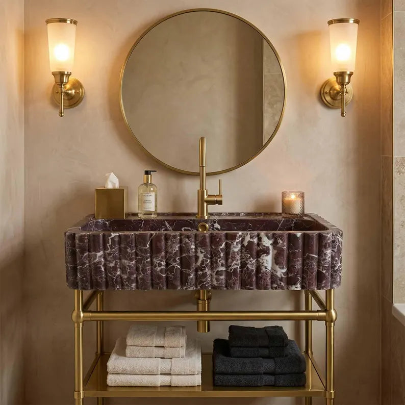 This is not a standard sink. It is a hand-carved dark marble fluted sink, sculpted from a single block of natural stone and designed as a seamless integrated sink and countertop.