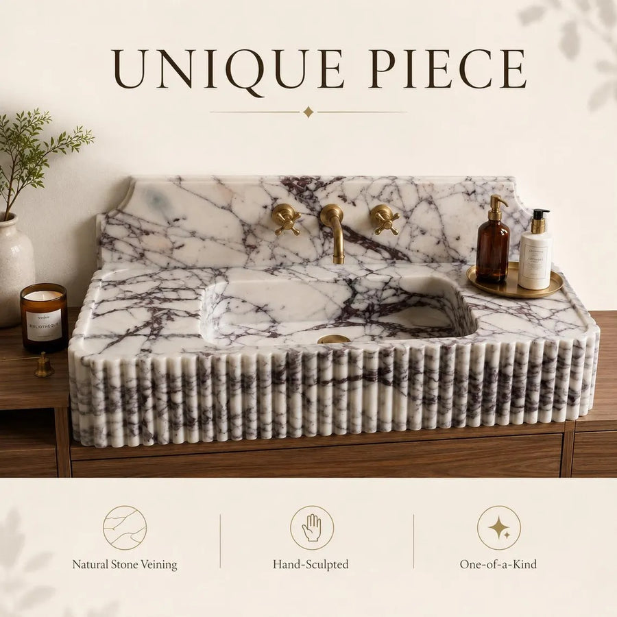 A luxury marble sink countertop with a ribbed front, integrated basin, and brushed brass faucet, shown in a styled bathroom setting with text overlays highlighting its unique features.